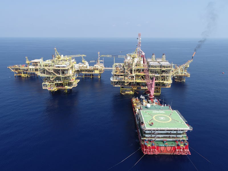 Aerial view of offshore oil rigs at sea